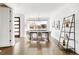 Bright dining room with hardwood floors, modern light fixture and a large window with neighborhood views at 3333 Osage St, Denver, CO 80211