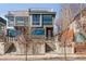 Modern multi-story home featuring a rooftop deck and an inviting entrance with concrete stairs and a stylish front door at 3333 Osage St, Denver, CO 80211