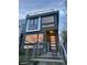 Eye-catching home with oversized windows and an elevated rooftop terrace, secured by a metal fence and front gate at 3333 Osage St, Denver, CO 80211