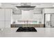 Modern kitchen with stainless steel appliances, gas cooktop, and a large island with a black range at 3333 Osage St, Denver, CO 80211