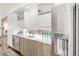 Sleek kitchen with stainless steel appliances, modern cabinets, and a window overlooking the yard at 3333 Osage St, Denver, CO 80211