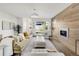 Bright living room with a modern fireplace, hardwood floors, large windows, and a comfortable seating arrangement at 3333 Osage St, Denver, CO 80211