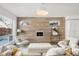 Bright living room features modern wood accent wall with fireplace, and large windows offering natural light at 3333 Osage St, Denver, CO 80211