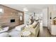 Modern open-concept living room with hardwood floors, fireplace, large windows, and view into the kitchen at 3333 Osage St, Denver, CO 80211