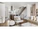 Open-concept living room with views into the modern kitchen and an iron-railed staircase at 3333 Osage St, Denver, CO 80211
