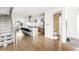 Open-concept kitchen and living space with hardwood floors and modern finishes throughout at 3333 Osage St, Denver, CO 80211