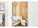 Stylish powder room with patterned wallpaper, floating sink, modern toilet and globe pendant lights at 3333 Osage St, Denver, CO 80211