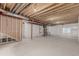 Unfinished basement with concrete floor, wrapped walls, and exposed wood ceiling at 1826 Hickory Ave, Erie, CO 80516