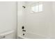 Modern bathroom featuring a tiled shower with black fixtures and a window at 1826 Hickory Ave, Erie, CO 80516