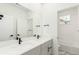 Modern bathroom featuring a double sink vanity with black hardware and tiled shower at 1826 Hickory Ave, Erie, CO 80516
