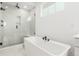 Modern bathroom featuring a luxurious soaking tub and a glass-enclosed shower at 1826 Hickory Ave, Erie, CO 80516
