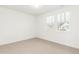 Bright bedroom featuring neutral carpet, large windows, and fresh, white walls at 1826 Hickory Ave, Erie, CO 80516