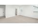 Spacious bedroom with plush carpet, large windows and doorway to en suite bath at 1826 Hickory Ave, Erie, CO 80516