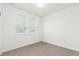 Bright bedroom featuring neutral carpet, large windows, and fresh, white walls at 1826 Hickory Ave, Erie, CO 80516