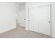 Bedroom featuring neutral carpet, white walls and doors, and a closet with sliding doors at 1826 Hickory Ave, Erie, CO 80516