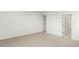 Spacious bedroom with neutral carpet and an adjoining bathroom at 1826 Hickory Ave, Erie, CO 80516