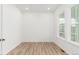 Light-filled bedroom with hardwood floors and a large window overlooking the neighborhood at 1826 Hickory Ave, Erie, CO 80516