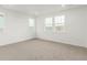 Bright bedroom with neutral carpet, double windows, and crisp, white trim at 1826 Hickory Ave, Erie, CO 80516