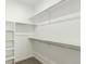 Walk-in closet with custom shelving and rod, maximizing storage space at 1826 Hickory Ave, Erie, CO 80516