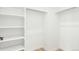 Bright walk-in closet with custom shelving and hardwood flooring at 1826 Hickory Ave, Erie, CO 80516