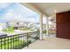 Covered porch with a view of a well-manicured lawn and a street with neatly lined houses at 1826 Hickory Ave, Erie, CO 80516