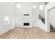 Spacious living room featuring a modern fireplace, large windows, and stylish wooden floors at 1826 Hickory Ave, Erie, CO 80516