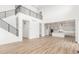 Spacious open-concept living room and kitchen with hardwood floors and modern finishes at 1826 Hickory Ave, Erie, CO 80516