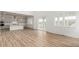Bright living room with a view of the kitchen, an open floor plan, and sliding doors to the backyard at 1826 Hickory Ave, Erie, CO 80516