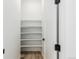 Walk-in pantry with open shelving and wood-look flooring at 1826 Hickory Ave, Erie, CO 80516