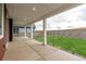 Inviting covered patio with elegant columns and a view of the lush backyard at 1826 Hickory Ave, Erie, CO 80516