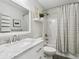 Clean bathroom features a marble vanity, a shower with decorative curtain, and modern fixtures for a stylish design at 208 N Foote Ave, Lafayette, CO 80026