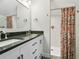 Well-lit bathroom with a double sink vanity, modern fixtures, and a tiled shower for a luxurious experience at 208 N Foote Ave, Lafayette, CO 80026