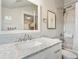 Well-lit bathroom features modern fixtures, marble countertop, and tiled shower for a clean and stylish design at 208 N Foote Ave, Lafayette, CO 80026