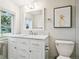 Bright bathroom features a white vanity with marble countertop, ample storage, and a modern toilet at 208 N Foote Ave, Lafayette, CO 80026
