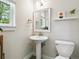 Cozy bathroom featuring a pedestal sink, modern fixtures, and a bright window for natural light and comfort at 208 N Foote Ave, Lafayette, CO 80026