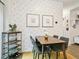 Stylish dining area featuring patterned wallpaper, modern furniture, and a chic wine rack for elegant entertaining at 208 N Foote Ave, Lafayette, CO 80026