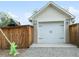 Detached two-car garage with traditional doors and exterior lighting at 208 N Foote Ave, Lafayette, CO 80026