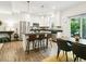 Bright kitchen boasts stainless steel appliances, white cabinets, and island with seating, perfect for modern living at 208 N Foote Ave, Lafayette, CO 80026