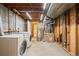 Utility area showing modern washer, dryer, water heater, and furnace at 8900 Iris Ct, Broomfield, CO 80021