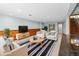 Finished basement living area with carpet, wood paneling, and comfortable seating at 8900 Iris Ct, Broomfield, CO 80021