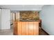 Basement wet bar featuring wood cabinetry and a stone backsplash for a rustic feel at 8900 Iris Ct, Broomfield, CO 80021