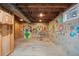 Unfinished basement with concrete floor and colorful murals at 8900 Iris Ct, Broomfield, CO 80021