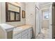 Bathroom with a sink vanity, framed mirror, and a closet with a shower visible at 8900 Iris Ct, Broomfield, CO 80021