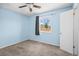 Bedroom with blue walls, a ceiling fan, neutral carpet, and a bright window at 8900 Iris Ct, Broomfield, CO 80021