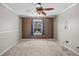 Simple bedroom with a ceiling fan, window, and neutral carpet at 8900 Iris Ct, Broomfield, CO 80021