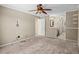 Bedroom view with a ceiling fan, carpeted floor, and an open bathroom at 8900 Iris Ct, Broomfield, CO 80021