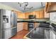 Modern kitchen featuring stainless steel appliances, granite countertops, ample cabinet space, and sleek fixtures at 8900 Iris Ct, Broomfield, CO 80021
