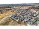 A sweeping aerial view showcases a neighborhood with modern townhomes surrounded by green spaces and trees at 5738 Urban Ctr, Arvada, CO 80002