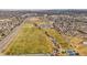 Aerial view of a large park area featuring sports fields, green spaces, trails, ponds, and surrounding neighborhoods at 5738 Urban Ctr, Arvada, CO 80002