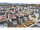 An aerial view of closely-packed homes featuring a scenic mountain backdrop at 5738 Urban Ctr, Arvada, CO 80002